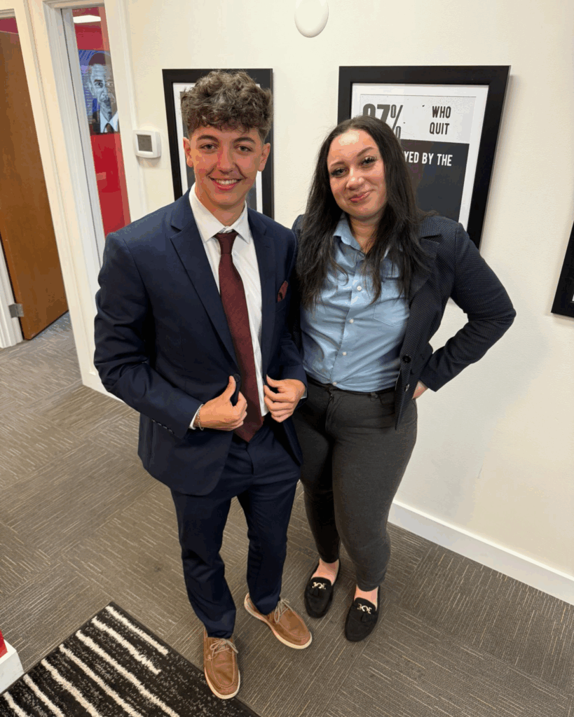 A new sales intern standing with a seasoned professional