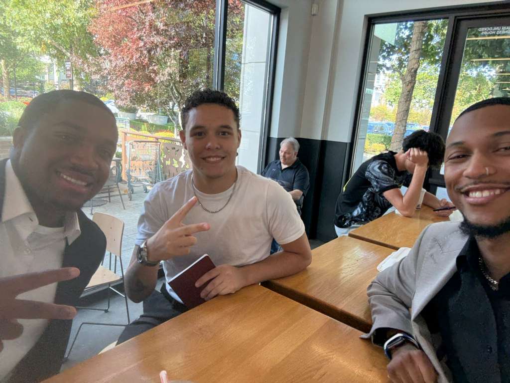Three male professionals smiling after an interview preparation.