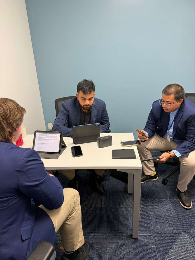 Sales team collaborating about outreach strategies.